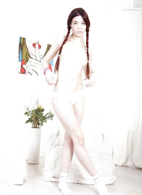 Curious redhead babe Lovenia Lux bares her ass in sexy panties and plays with dildo 